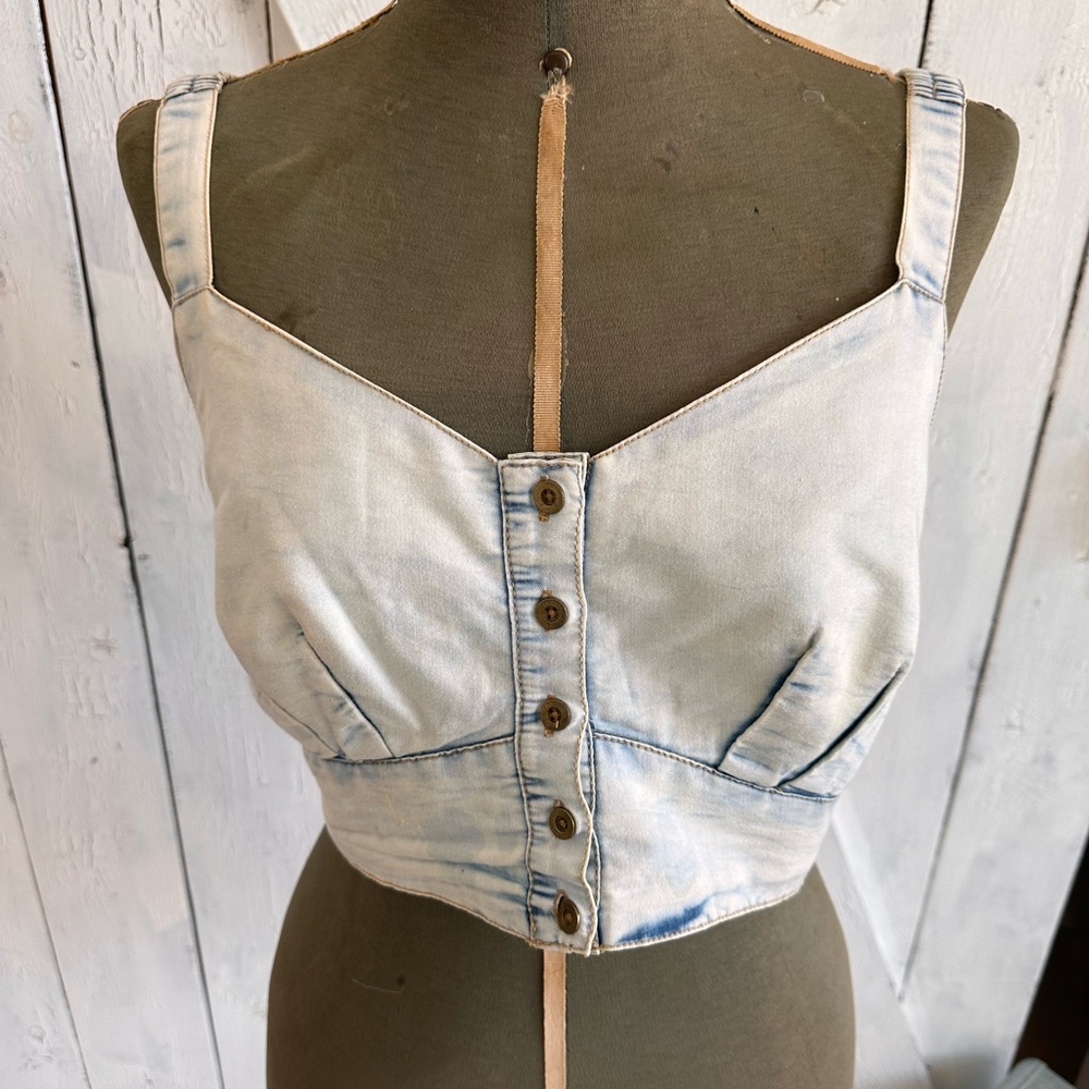 Size L, Light blue, acid washed denim crop-top with adjustable button straps.